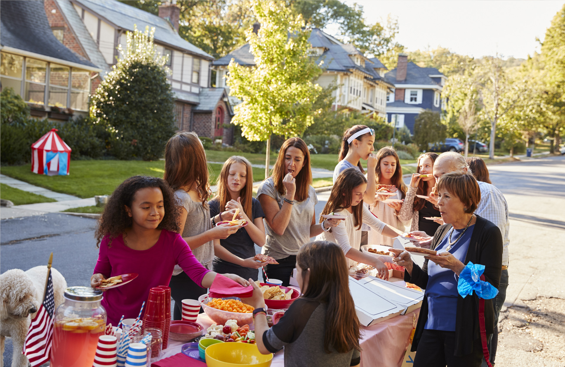 People eating food at neighborhood party