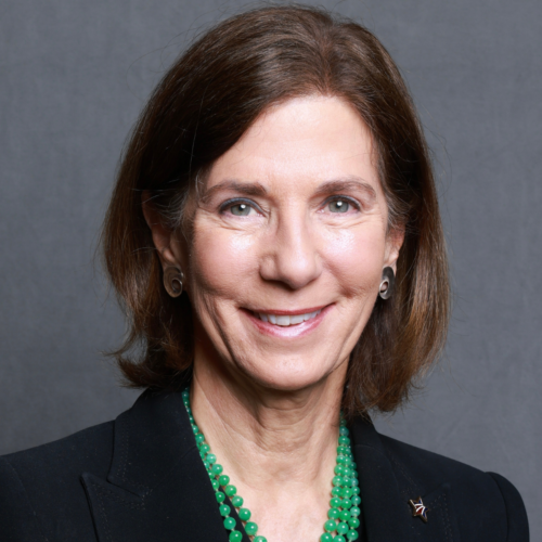 Margaret Davis, Volunteer of the Year 2026: Headshot of Margaret Davis, smiling, wearing a black blazer and a layered green beaded necklace.